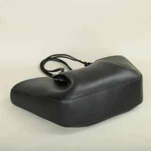 Detailed view of black leather pleated tote bag, elegant single shoulder handbag design.