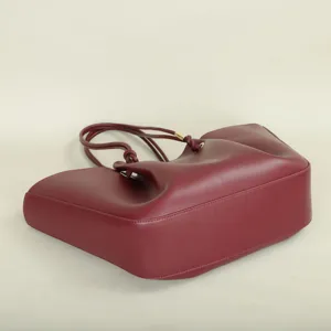 Burgundy leather tote bag with knotted handles and large capacity, ideal for daily commute.