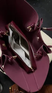 Burgundy leather tote bag large capacity commuter shoulder handbag with knotted handles.