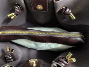 Detailed view of luxury leather tote bag interior, premium hardware and craftsmanship.