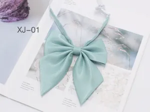 Detailed view of a mint green shiny JK bow tie, perfect for school uniform and daily wear.