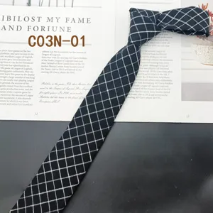 Close-up detail of a classic black grid narrow tie, stylish retro design for casual wear.