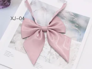 Detailed close-up of the sparkling pink JK uniform bow tie, cute college style collar accessory.
