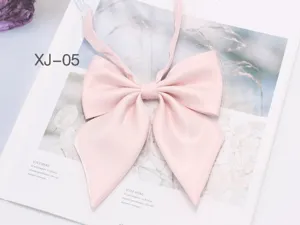 Detail view of a shiny pink JK uniform bow tie with pointed big wing design and ribbon.