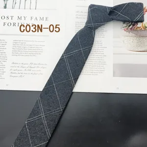 Detail view of mens narrow grey plaid tie fabric texture close up casual neckwear