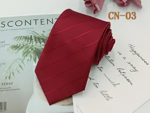 Wine red striped necktie detail shot, classic business formal wear accessory for men.