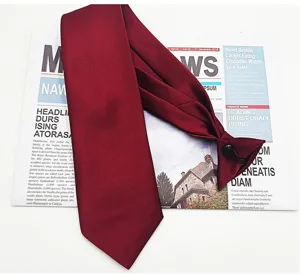 Detail shot of a burgundy pre-tied business tie with adjustable strap on white background.