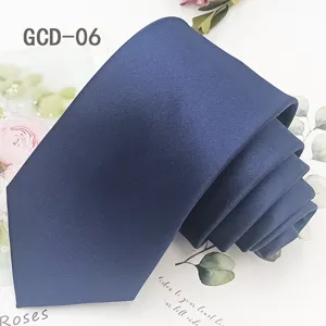 Solid navy blue polyester tie fabric detail shot, classic business formal wear accessory.
