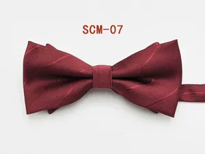 Close-up view of wine red men's formal bowtie showing smooth fabric texture and details.