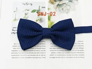 Dark blue textured dot men bow tie detail view, elegant fabric close up for formal wedding.