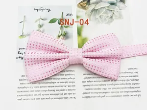 Detail view of the pink dotted bow tie texture, showcasing the fine fabric weave and neat folds.
