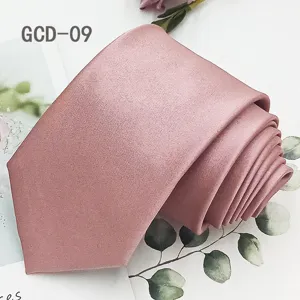 Detailed view of a solid pink necktie, stylish fabric texture, perfect for formal business attire.
