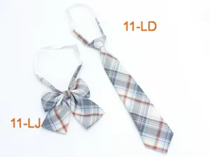 Closeup detail of Japanese JK uniform plaid bow and tie set in blue and grey tartan pattern.