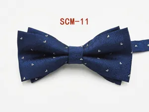 Detailed view of a dark blue double-layer men's bow tie with delicate white dot patterns.