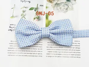 Detail view of a stylish blue polka dot men's bow tie, perfect for formal suits and grooms.