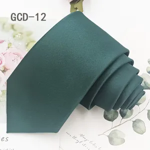 Detailed view of dark green solid necktie rolled neatly on decorative background, elegant style.