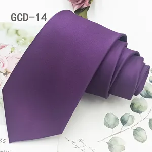 Detailed close-up view of a purple solid tie neatly rolled on botanical background.