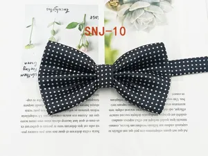 Classic navy blue men's bow tie with white polka dots, ideal for formal business suits.