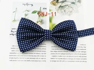 Detail view of a classic blue men's polka dot bow tie, showing fine fabric texture and neat dots.