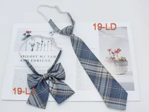 Detail shot of Japanese JK uniform plaid tie and bow set in blue gray grid pattern.