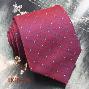 Close-up detail shot of a classic red jacquard woven men's necktie with elegant patterned lines.
