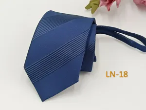 Close-up detail of the classic blue striped zipper necktie showing refined jacquard texture.