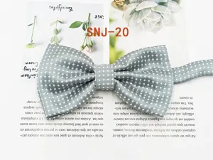 Detail view of grey polka dot men bow tie, elegant polyester silk accessory for formal wear.