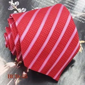 Red striped men's necktie detail close-up view, elegant jacquard woven polyester fabric.