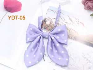 Detailed closeup of the purple polka dot bow tie, featuring cute sweet JK style.