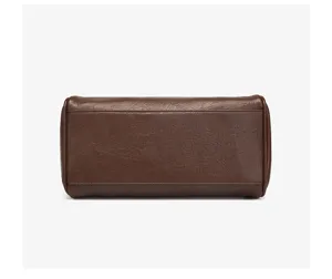Brown leather handbag detail shot, vintage retro design for daily commute and elegant office use.