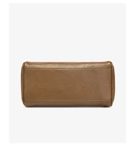Detailed close-up view of the brown leather bag bottom structure, showing fine texture and stitching.