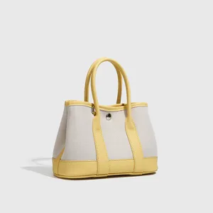 Piccolo borsa tote in tela bicolore, elegante borsa a mano gialla e bianca per donne moderne.