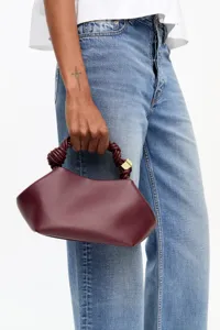 Burgundy women handbag casual shoulder bag simple shell bag detailed shot showing knotted handle