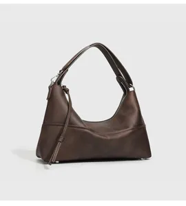 Dunkelbraune Hobo Schultertasche Detail, elegante minimalistische Form, glatter Reissverschluss.