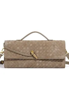 Chic woven leather baguette shoulder bag with stylish metal knot accent for women daily use.