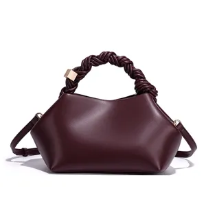 Stylish burgundy women's shoulder crossbody bag with braided handle and metal buckle.