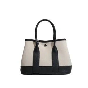 Piccola borsa tote in tela bicolore elegante con manici in pelle per donna stile quotidiano.