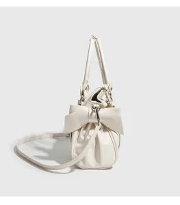 Chic white bow handbag for women, stylish PU leather shoulder and crossbody bag for daily wear.