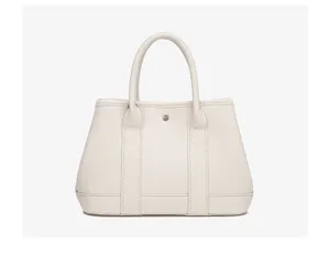 Classic off-white leather tote bag, elegant minimalist handbag for daily use now.