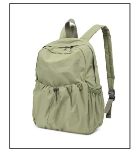 Sage green nylon backpack detail, lightweight casual daypack with front drawstring pocket.