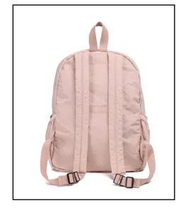 Pink nylon backpack detail view, casual minimalist design with adjustable straps and top handle.