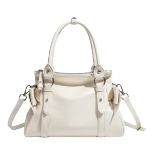 White motorcycle style shoulder bag with bow detail, versatile leather handbag for women.