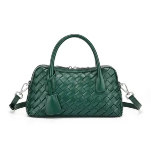 Dunkelgrüne geflochtene Ledertasche Detail, edle Textur, eleganter Schultergurt und zwei Griffe.