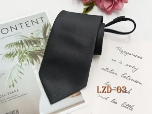 Close-up detail shot of black men's zipper necktie showing premium fabric texture clearly.