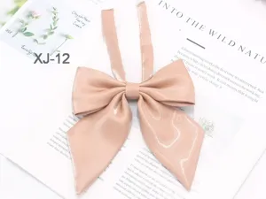 Detailed close-up shot of a sparkling pink JK uniform bow tie with long ribbons.