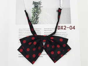 Detailed close-up of the black and red polka dot JK bow tie, showing the layered fabric texture.