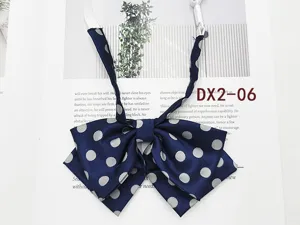 Navy blue polka dot bow tie detail, Japanese JK uniform collar accessory close-up view.