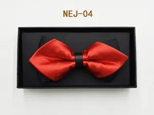 Close-up of red and black layered bow tie with leather ring in elegant gift box packaging.