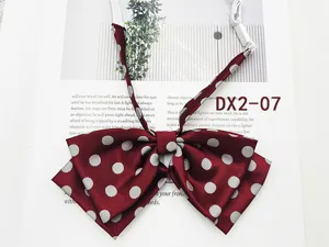 Detail view of wine red polka dot JK uniform bow tie, double layer sailor collar accessory.