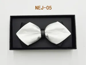 Detail shot of a stylish black and white bow tie in a black gift box, perfect for formal wear.